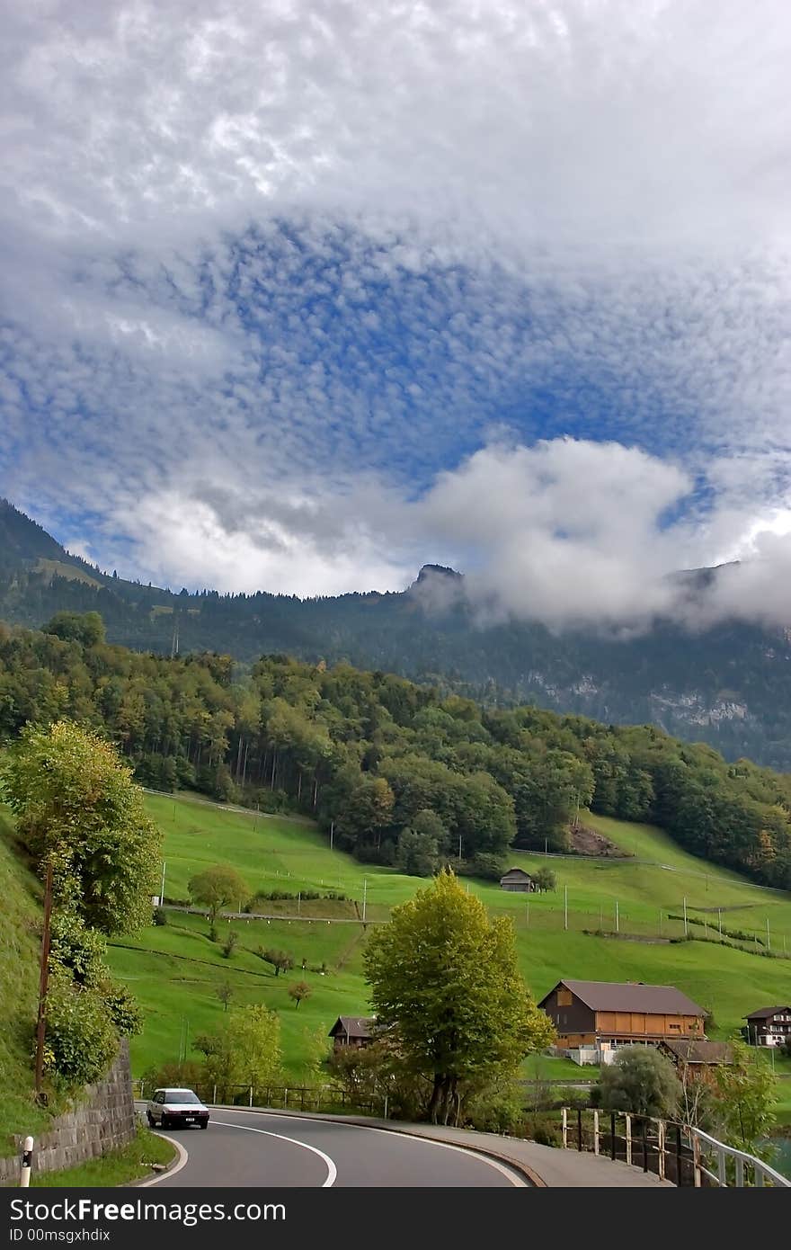 Road, placed in Switzerland Alps between green meadows. Road, placed in Switzerland Alps between green meadows.