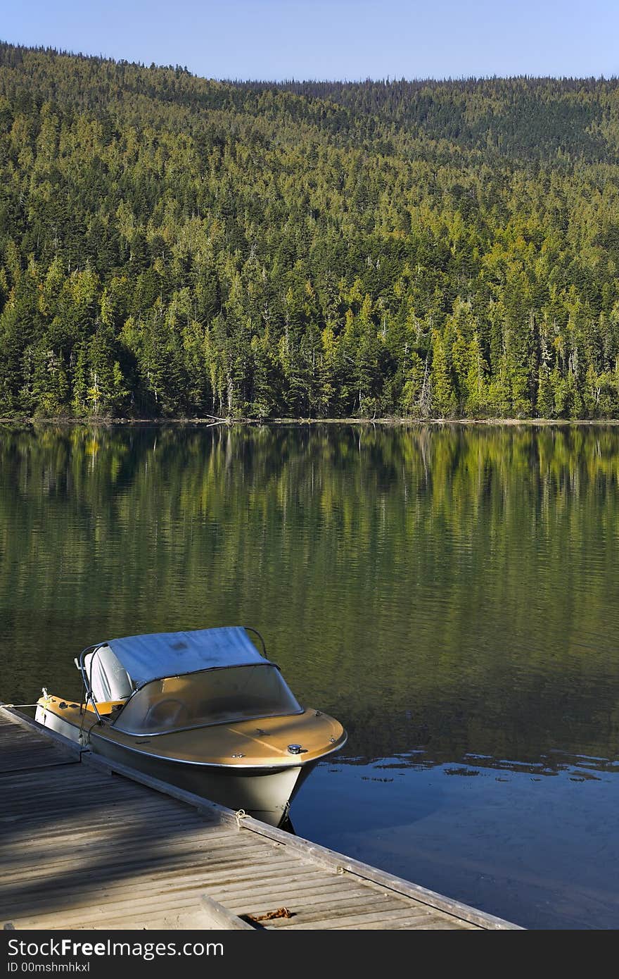 The fishing boat at a mooring of silent mountain lake. The fishing boat at a mooring of silent mountain lake