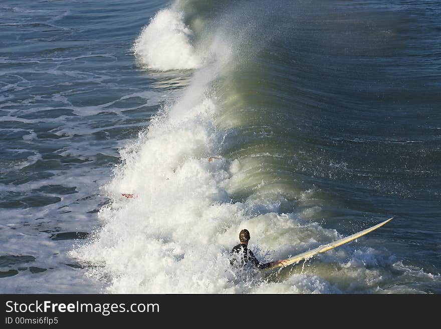 Surfers practicing ridng the waves,colorful waters. Surfers practicing ridng the waves,colorful waters