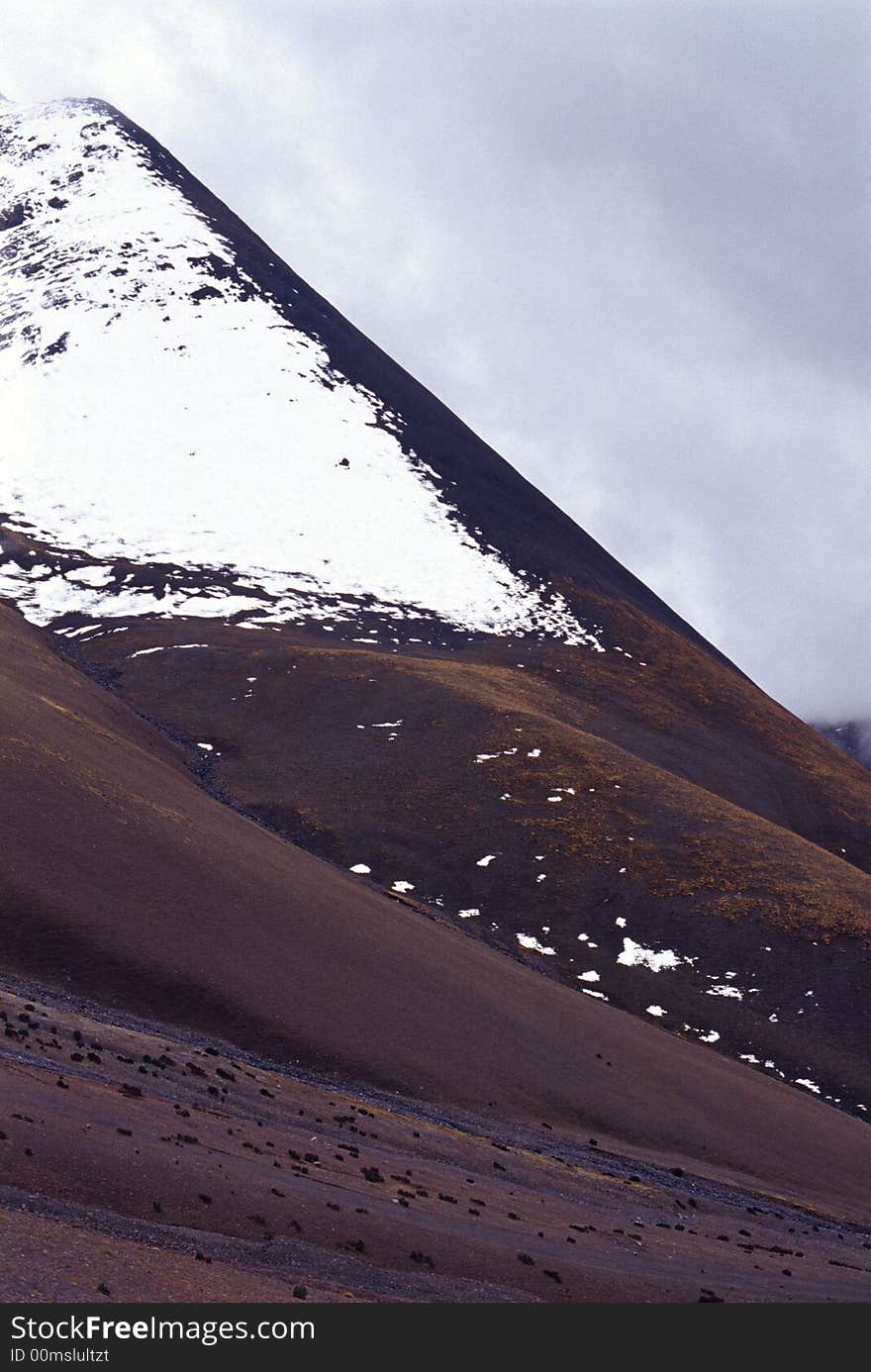 It is a snow mountain, with red Soil。 the location is Tibet of China
See more my images at :) http://www.dreamstime.com/Eprom_info