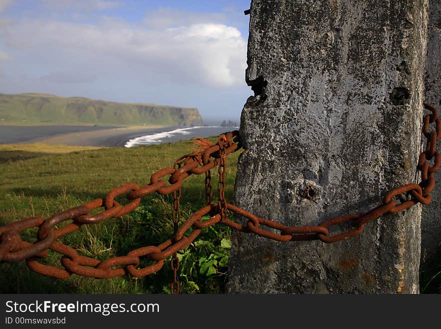 Concrete post view over to the sea stacks Iceland