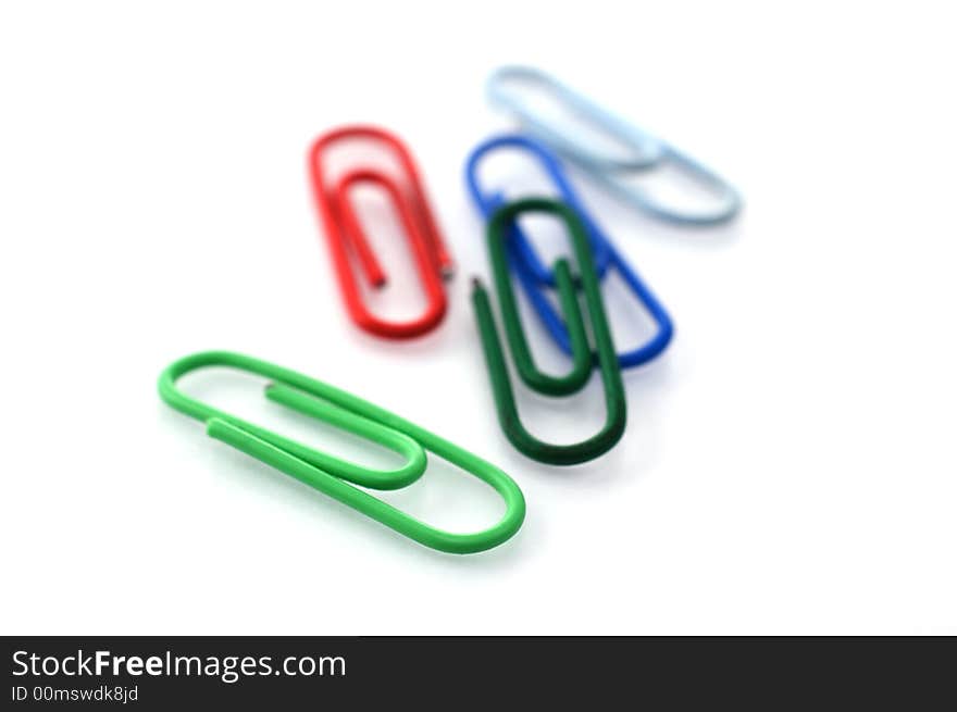 Colored paper clips isolated on white with shallow depth of field. Colored paper clips isolated on white with shallow depth of field