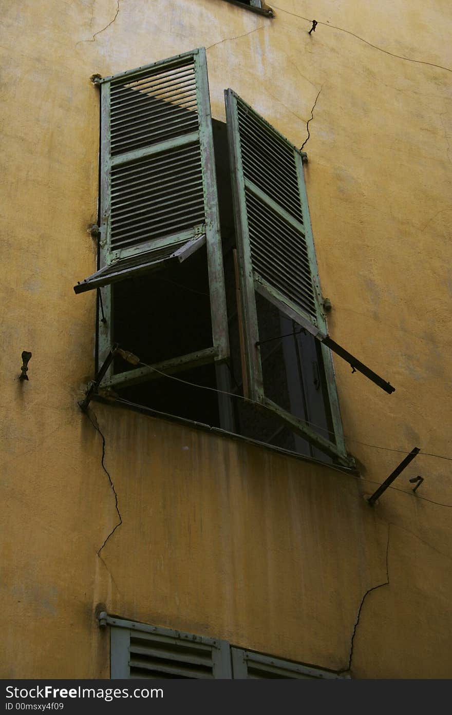 Window with green shutters in the old house. Window with green shutters in the old house