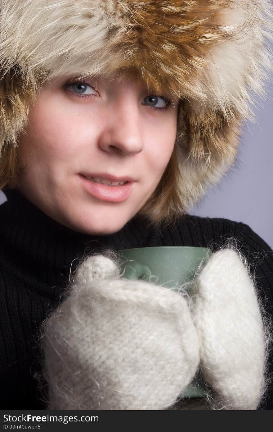 Pretty woman in winter hat with cup. Pretty woman in winter hat with cup