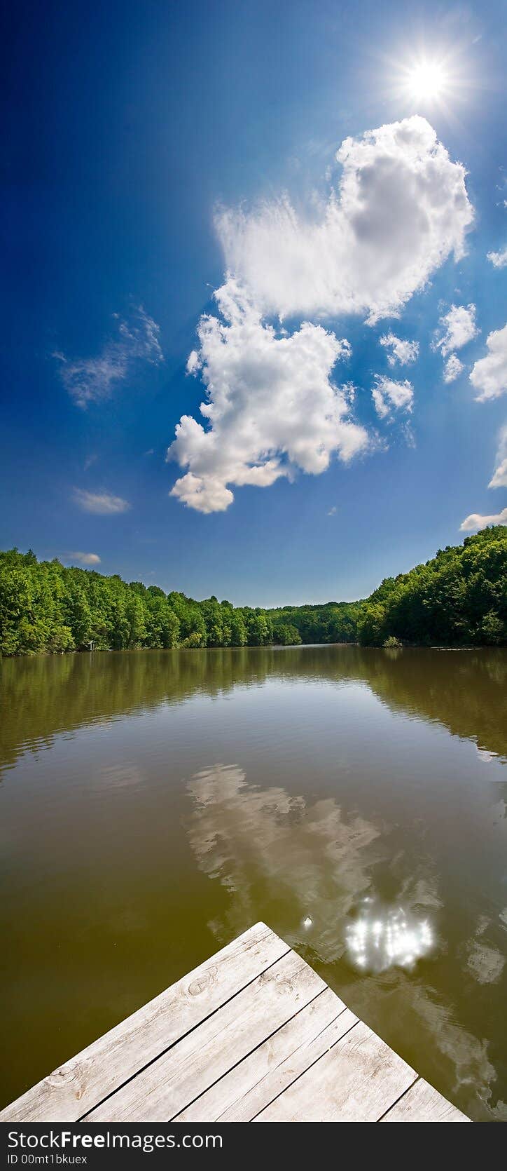 Summer landscape with the clouds and lake. Summer landscape with the clouds and lake