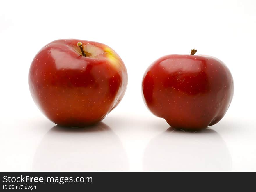 Ripe red apples on a white background