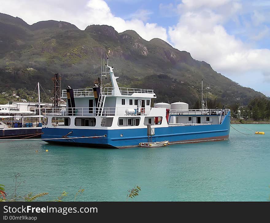 The ship costs on an anchor at mountainous coast. Seychelles.