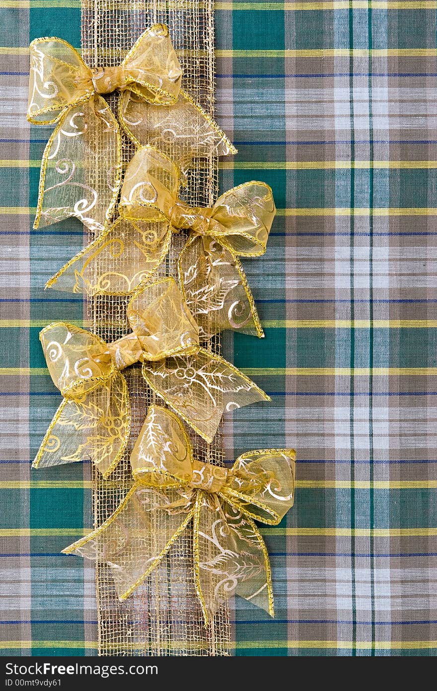 Holiday christmas packing from a fabric and gold bows. Holiday christmas packing from a fabric and gold bows