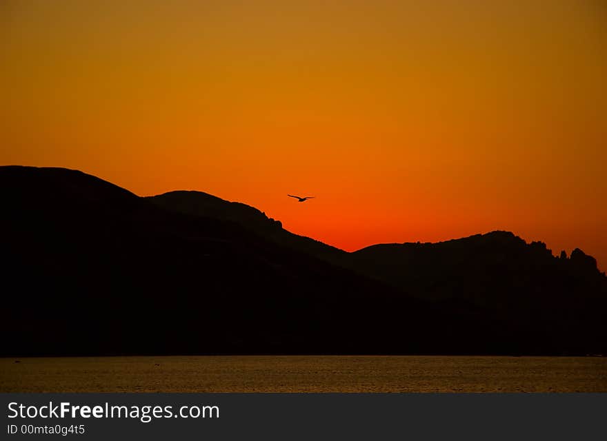 Orange sunrise from mountains and sea