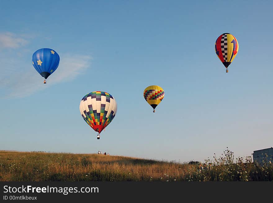 Balloons gathering together over a field. Balloons gathering together over a field.