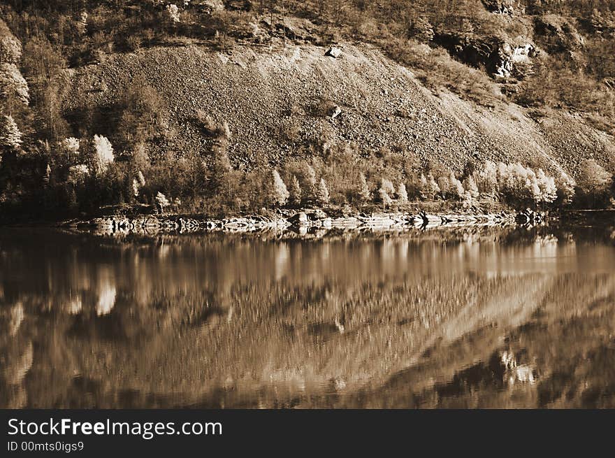 The reflection a hill side on the Alps in Italy. The reflection a hill side on the Alps in Italy