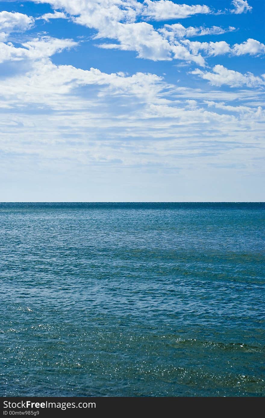 Calm Waves And Cloudy Blue Skies