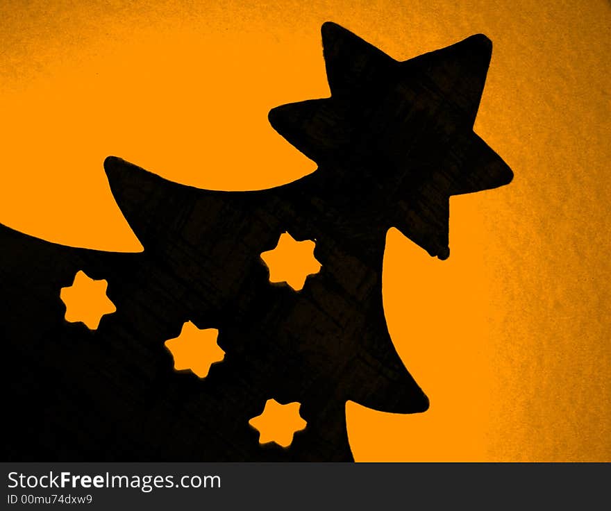 Christmas tree silhouette with stars on orange background