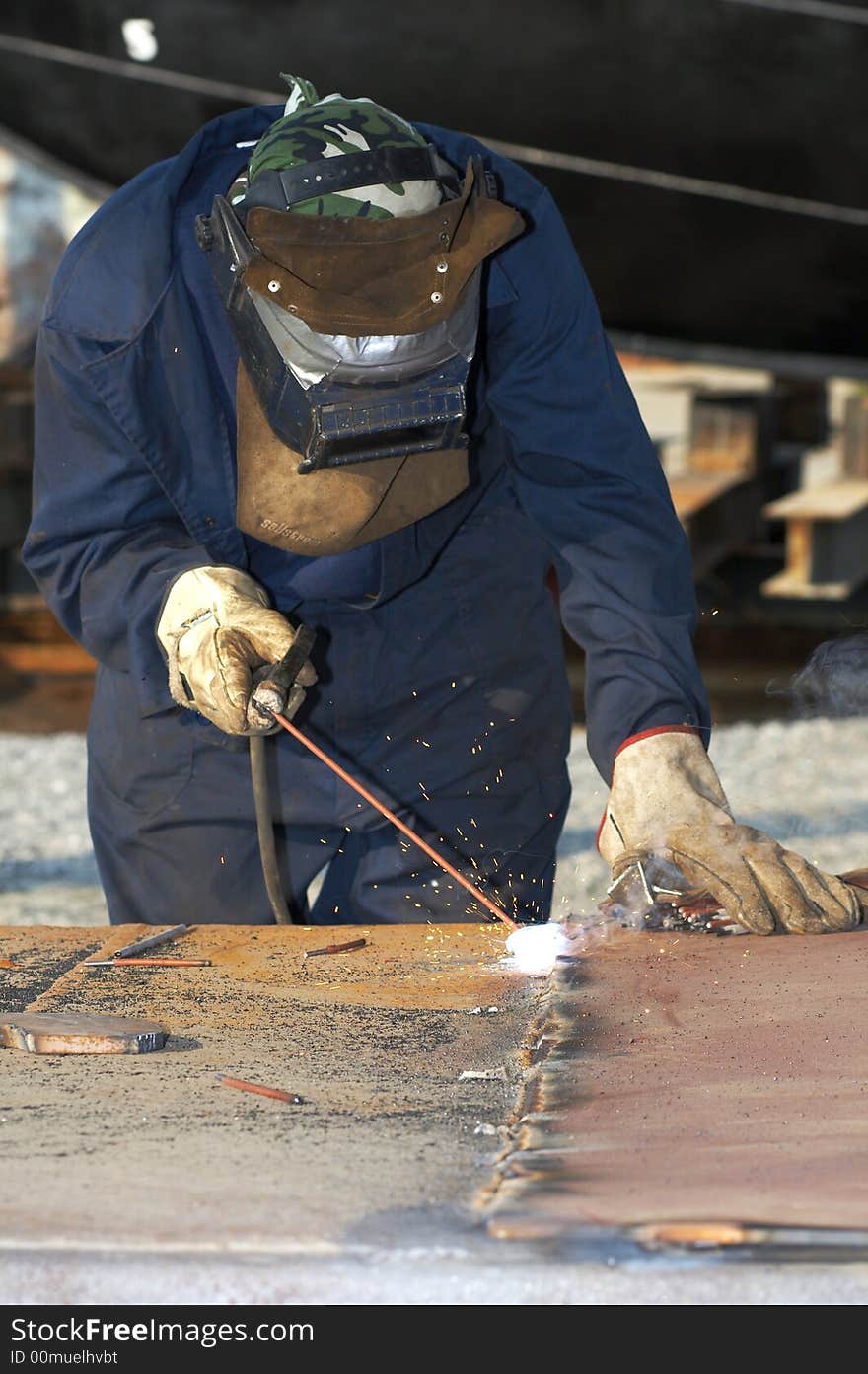 Welder at shipyard working on steel project. Welder at shipyard working on steel project