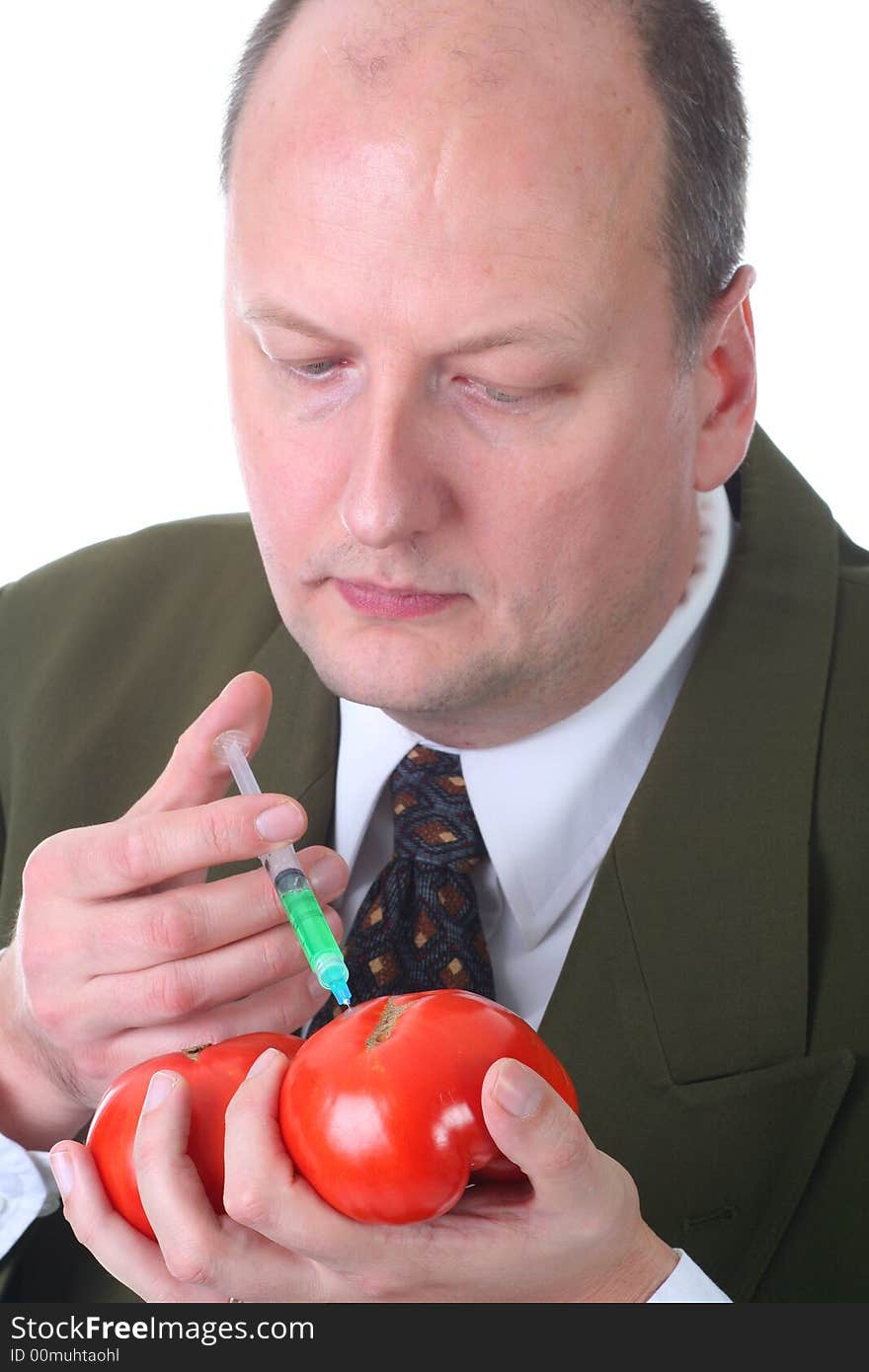 Scientist injecting tomatoe with hormone growth