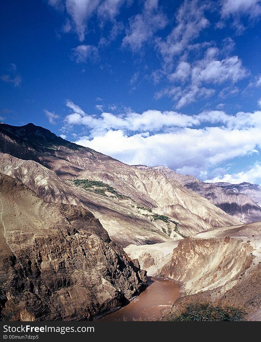 There is a river in the mountains. since has sands so the river has yellow color.
See more my images at :) http://www.dreamstime.com/Eprom_info