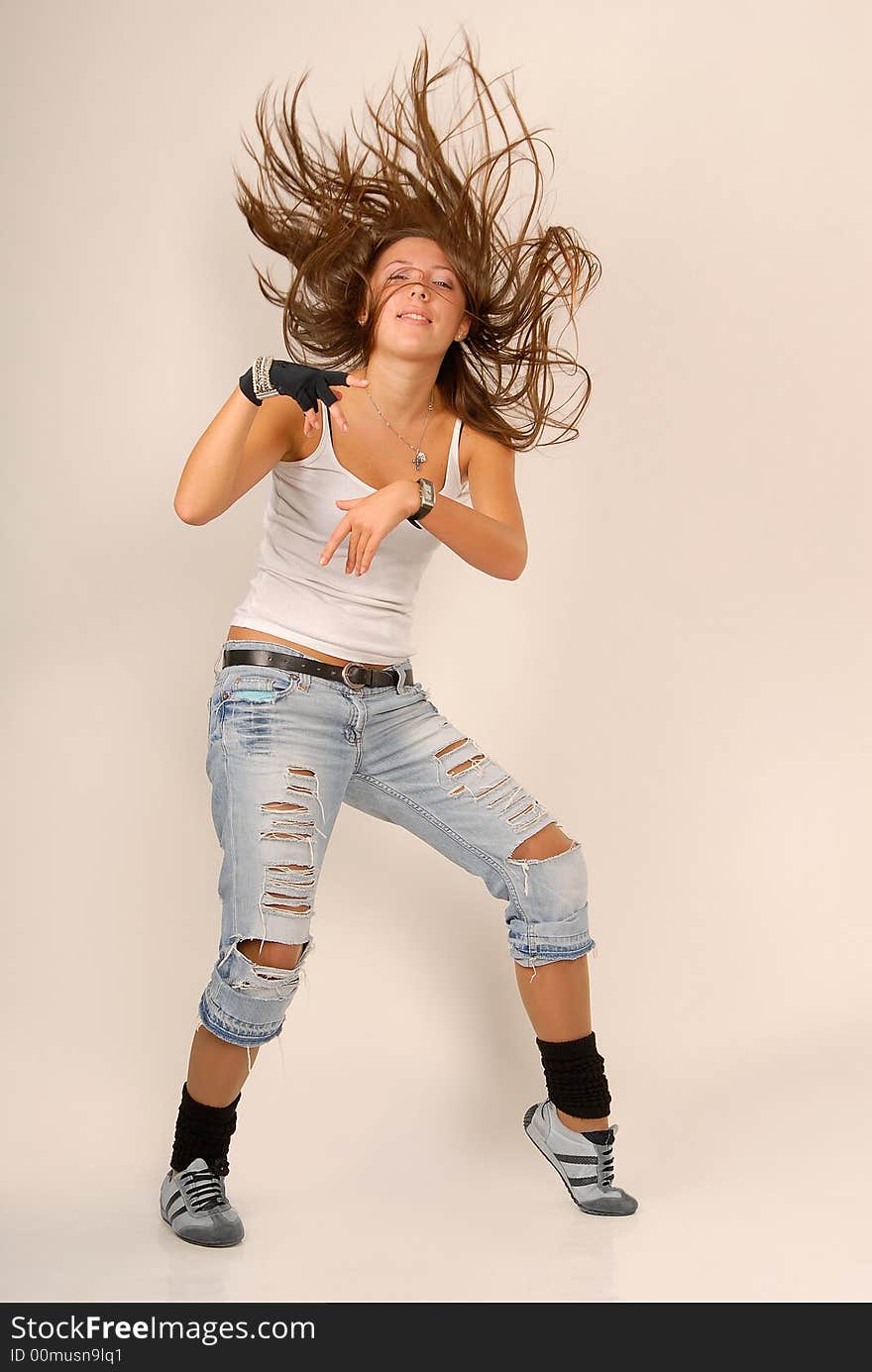 Dancing girl in white blouse and with black glove and tousled hair on the white background. Dancing girl in white blouse and with black glove and tousled hair on the white background