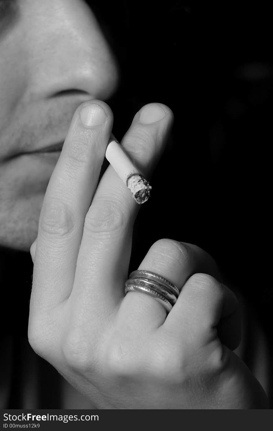 Men smoking cigarette, white and black photo. Men smoking cigarette, white and black photo