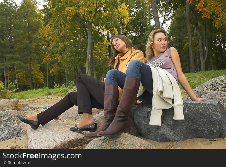 Two girls having a rest in autumn park. Two girls having a rest in autumn park