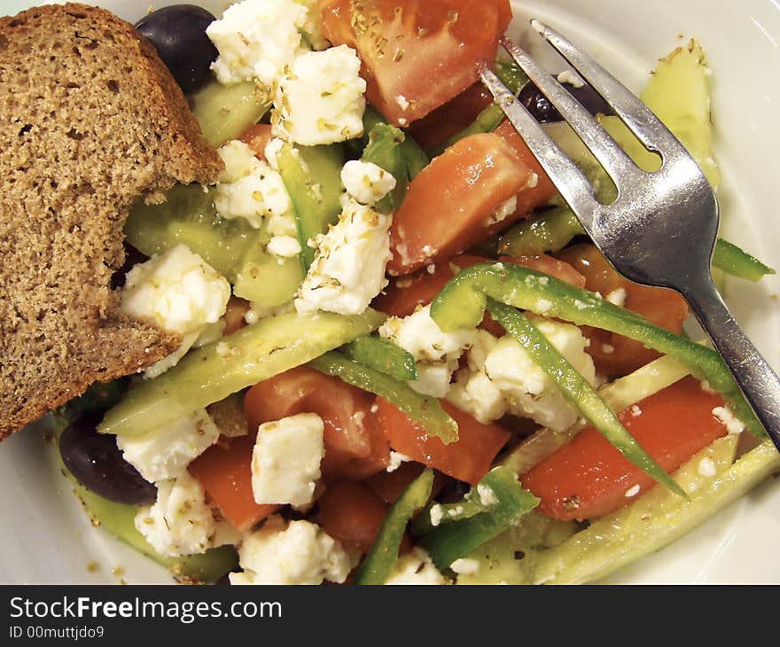 Detail of fresh salad with bread and fork. Detail of fresh salad with bread and fork