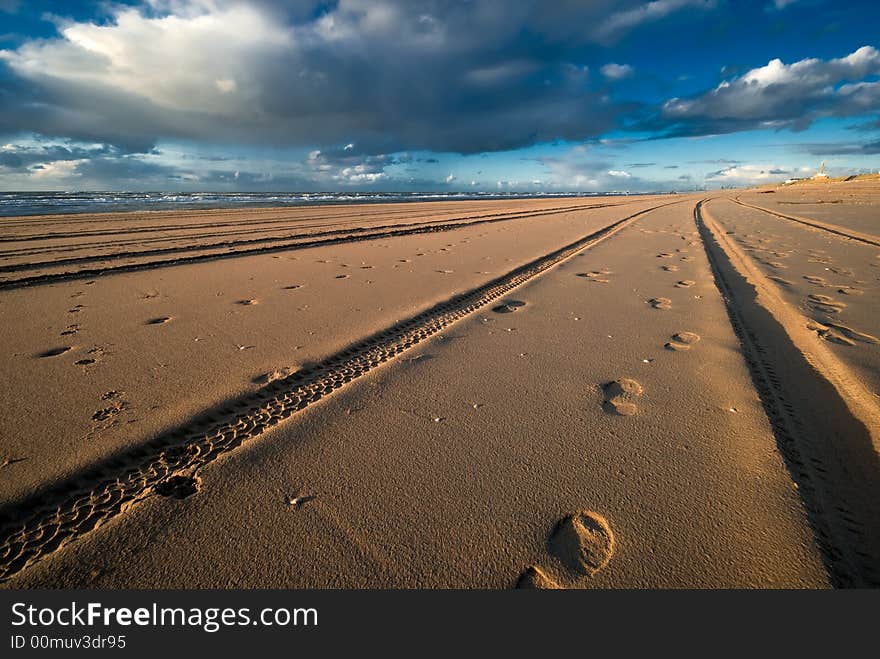 Tracks and footsteps on the beach