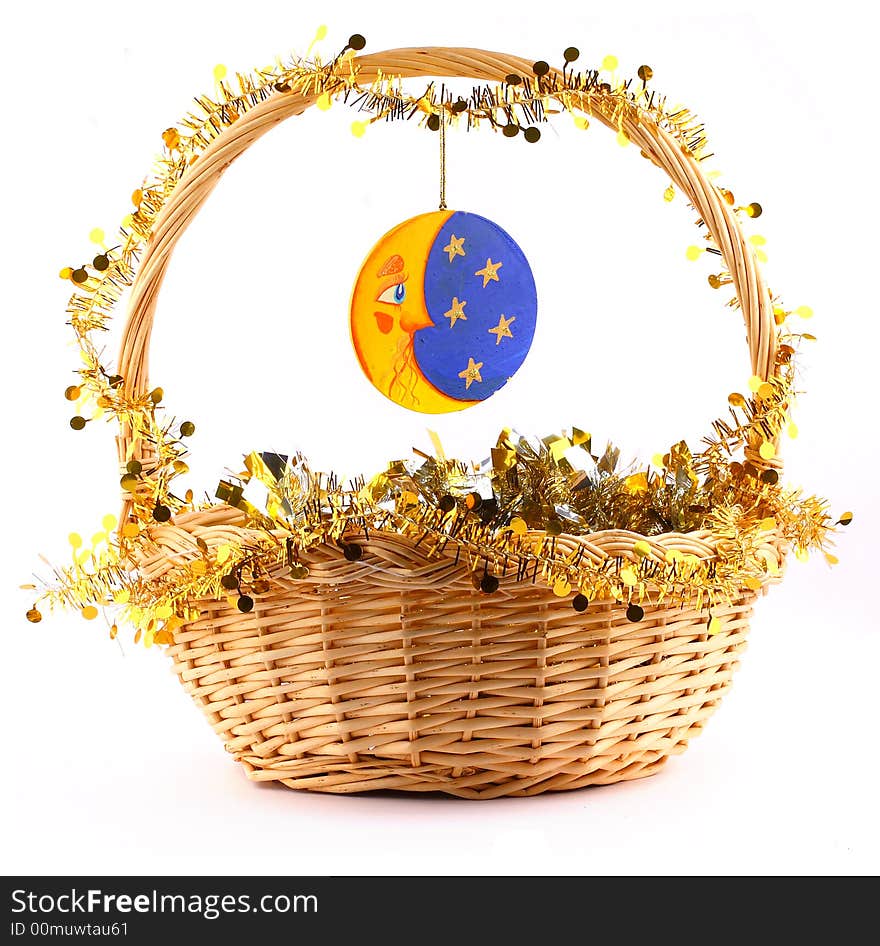 Wooden moon attached to string to the present basket witha a gold garland. Wooden moon attached to string to the present basket witha a gold garland