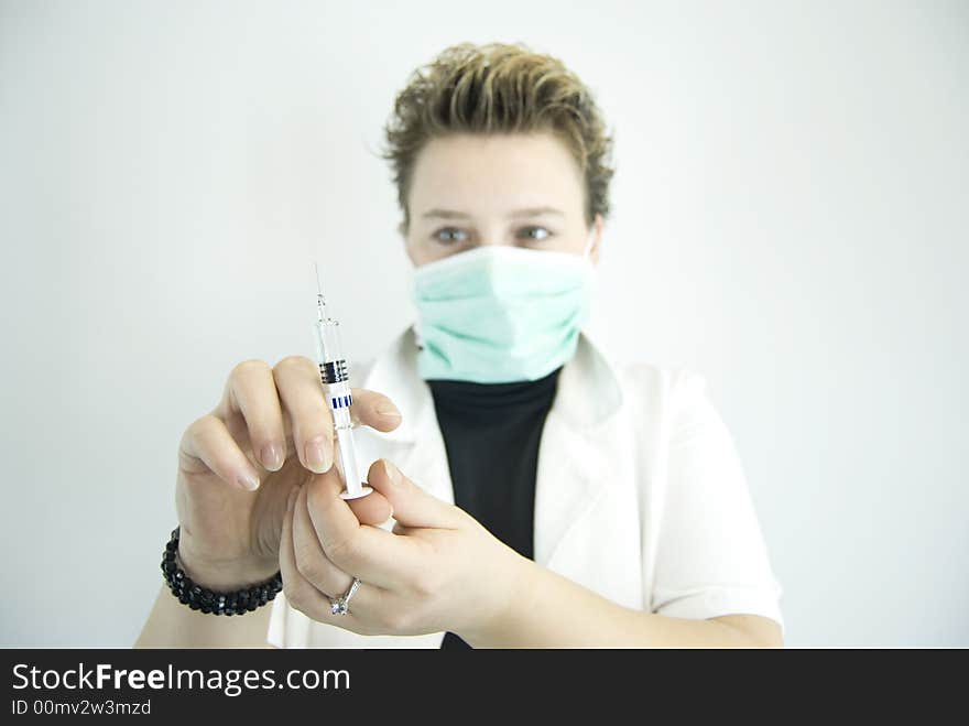 Young female doctor preparing injection