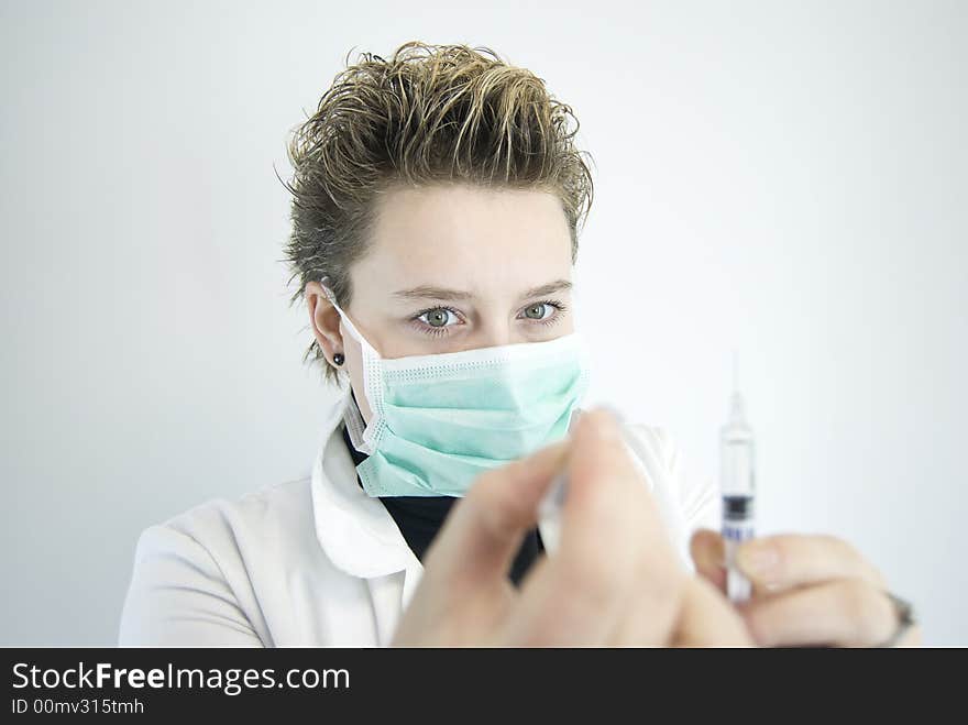 Young female doctor preparing injection