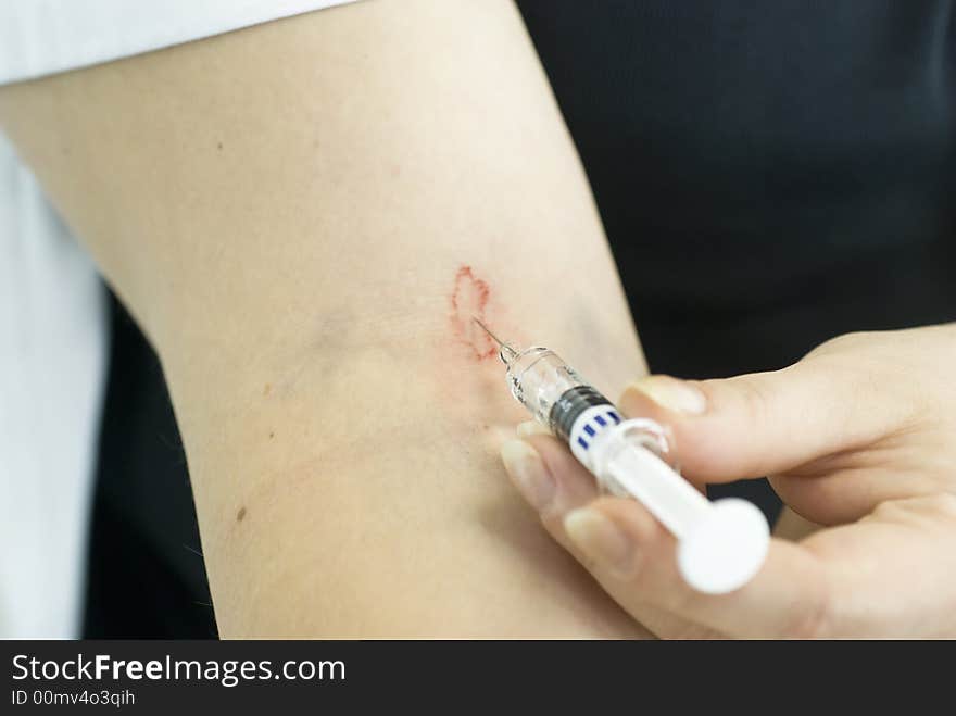 Close up of hand giving injection