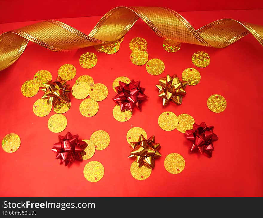 Red and golden bows and celebration ribbon