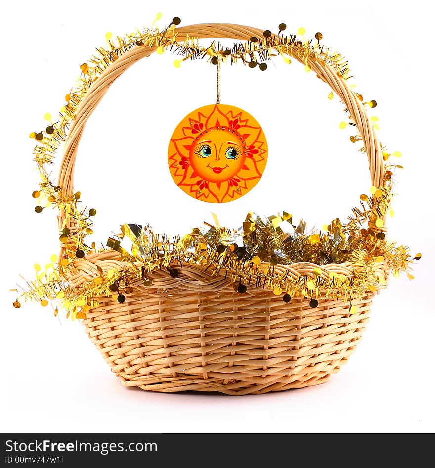 Wooden sunny attached to string to the present basket with a gold garland. Wooden sunny attached to string to the present basket with a gold garland