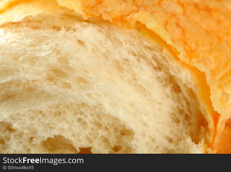 Slice of fresh bread with a cheese crust, background