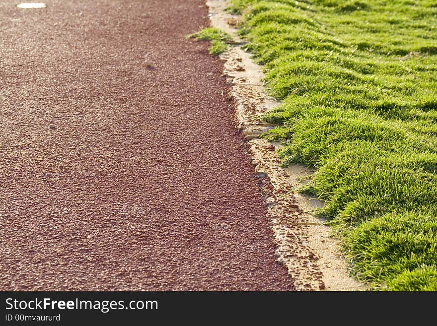 Abstract background showing part of the ground and the grass covering the football court... Shallow depth of field. Abstract background showing part of the ground and the grass covering the football court... Shallow depth of field...