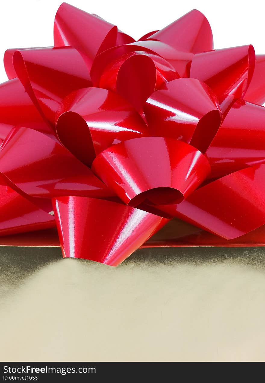 Christmas present wrapped with a large red bow on top, isolated on white