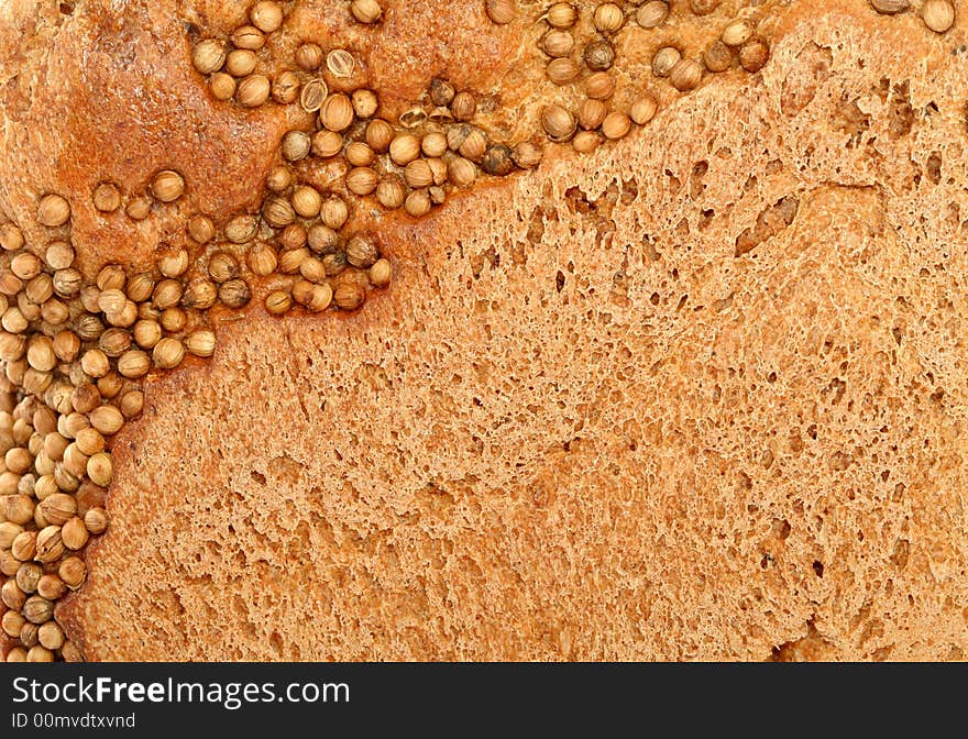 Crust of bread with seeds of a coriander, background. Crust of bread with seeds of a coriander, background