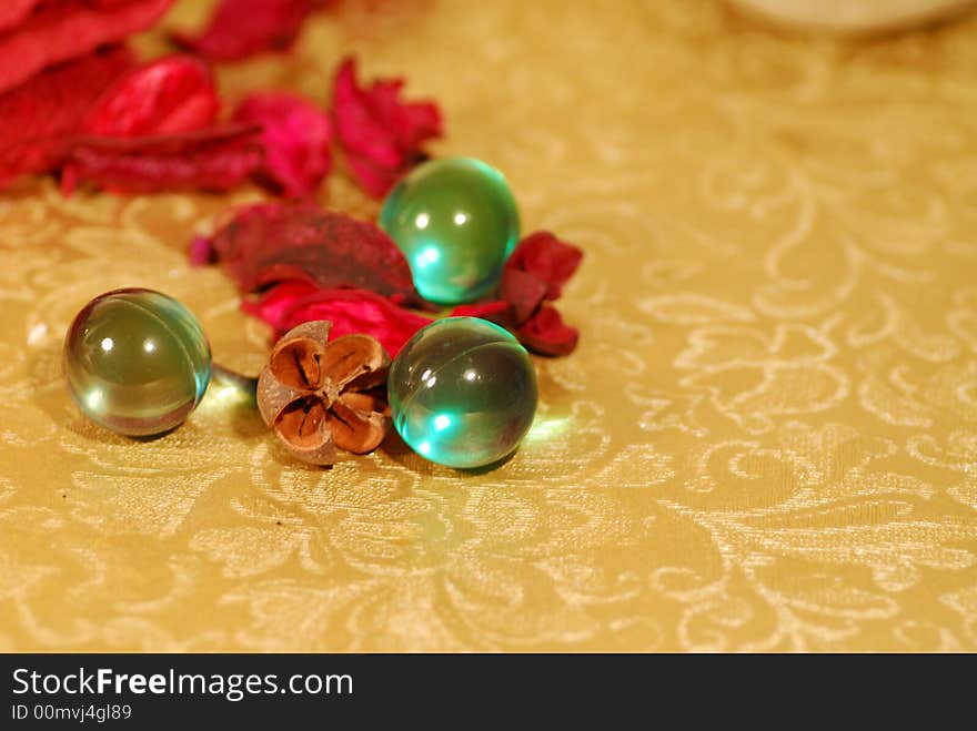 Spa and welness image with golden background and turquoise soap pearls