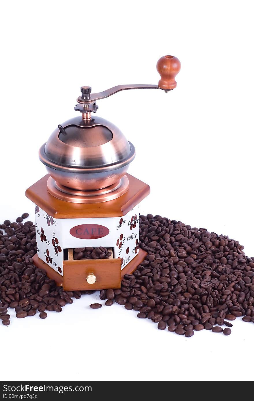 Antique coffee grinder with spilled beans