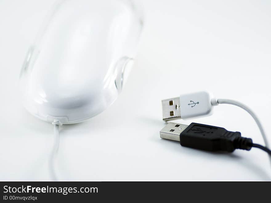Modern style mouse with two black and white USB plugs. Modern style mouse with two black and white USB plugs