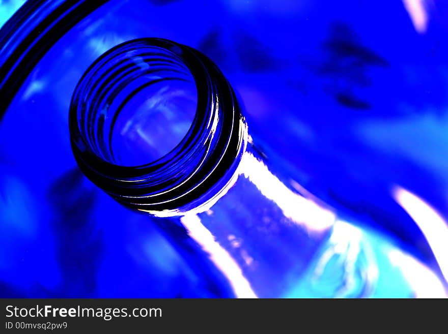 Mouth and neck of cobalt blue bottles with reflections