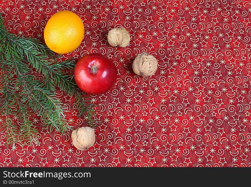 Red christmas background with pine and fruits