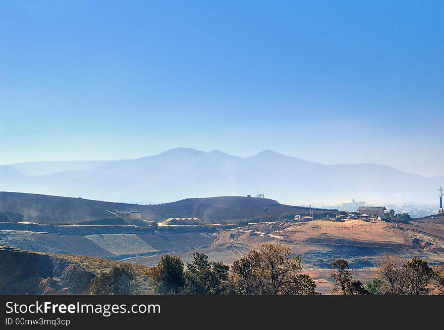 The picture with clean blue sky and fantastic farmhouse was taken in the morning at a grazing land. The picture with clean blue sky and fantastic farmhouse was taken in the morning at a grazing land.