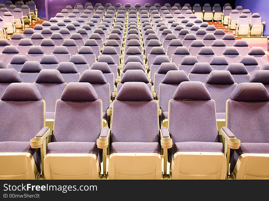 Empty cinema auditorium with blue chairs