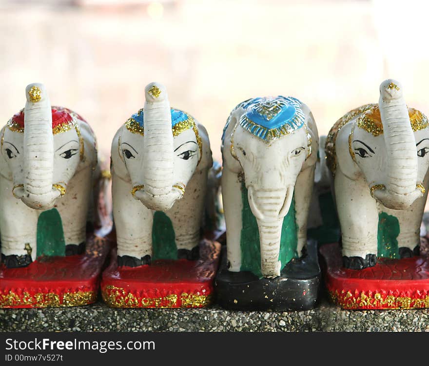 Tiny white elephant statues in a row. Tiny white elephant statues in a row.