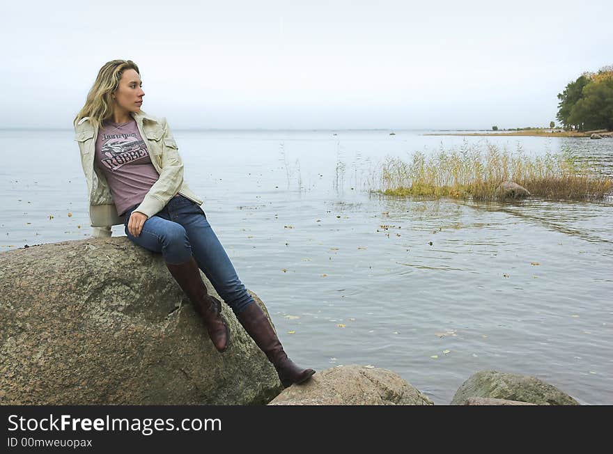 The beautiful girl has a rest on coast