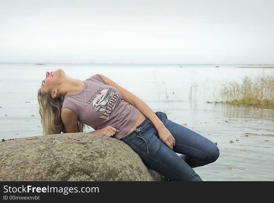 The beautiful girl has a rest on coast