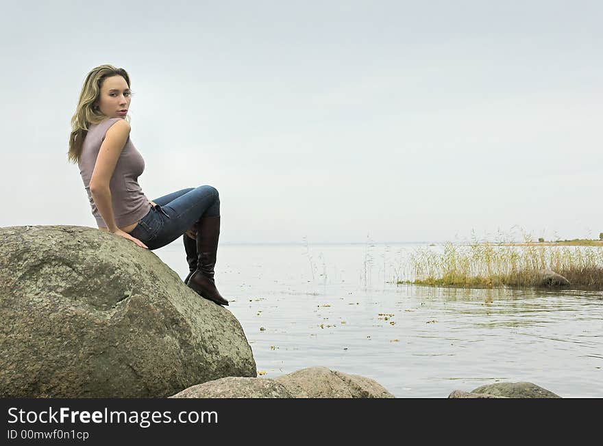 The beautiful girl has a rest on coast