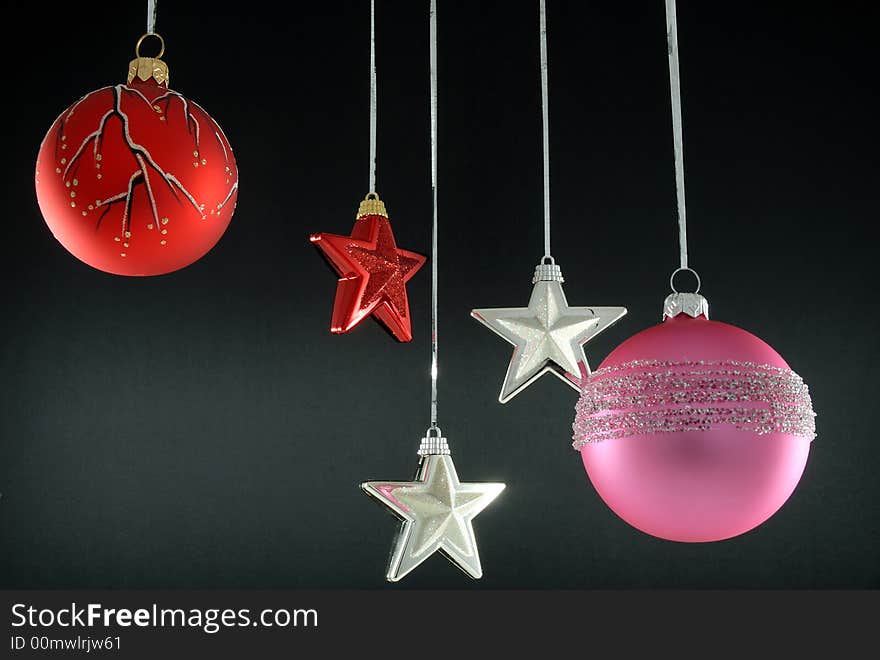 Hanging christmas tree ornaments on black background. Hanging christmas tree ornaments on black background