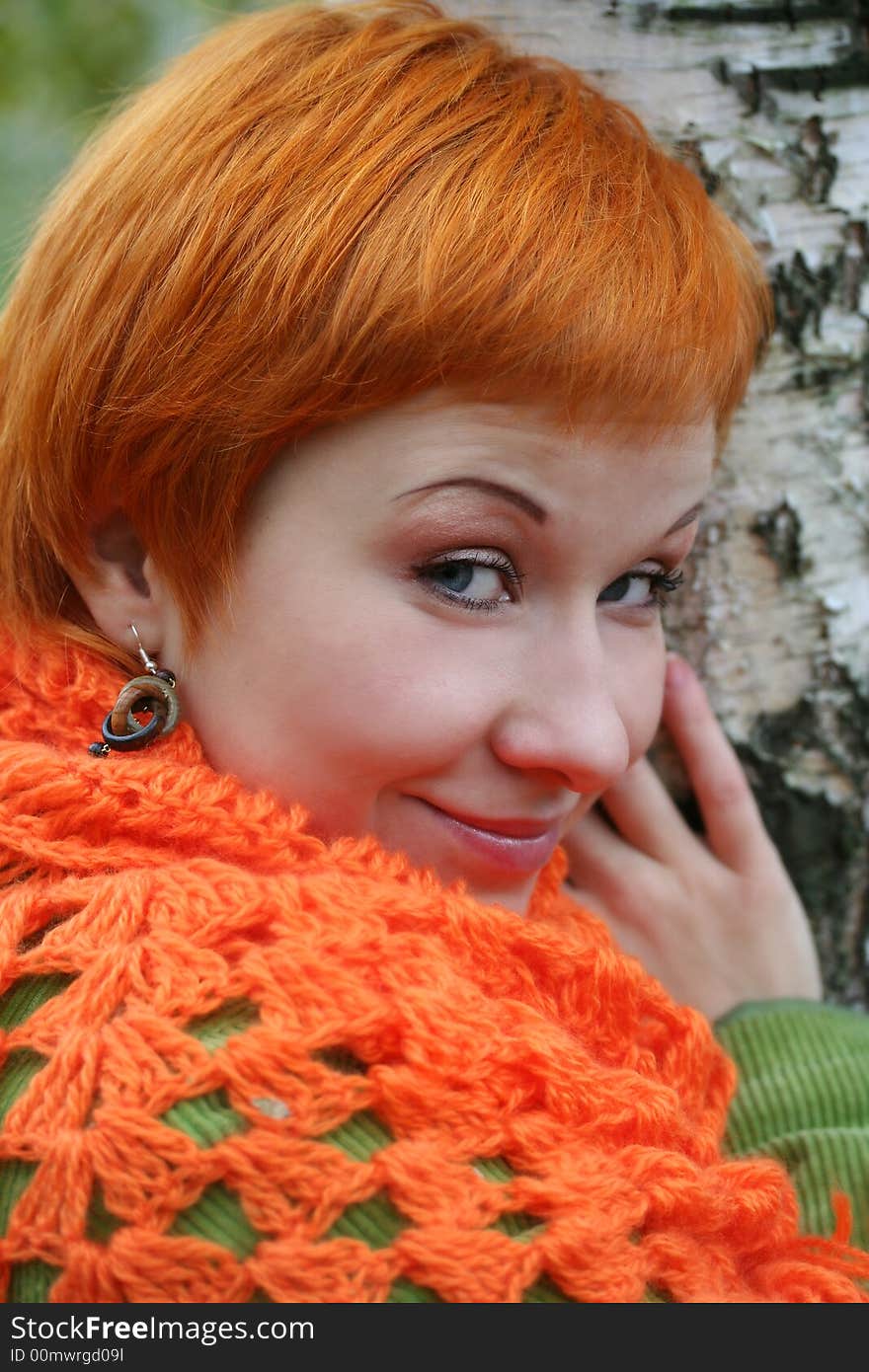 Young red-haired woman in red scarf. Young red-haired woman in red scarf