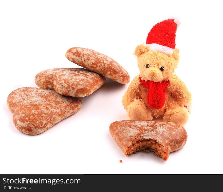 Santa teddy bear on bitten cake and pile of three honey-cakes. Santa teddy bear on bitten cake and pile of three honey-cakes