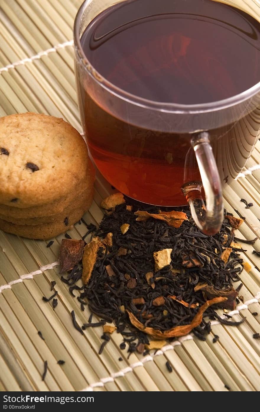 Glass tea, dried tea leaves and cookies. Glass tea, dried tea leaves and cookies